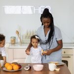 Mother with children enjoying breakfast together in a cozy kitchen setting.