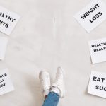 Inspirational health and fitness messages with shoe-clad feet, promoting healthy habits and wellbeing.